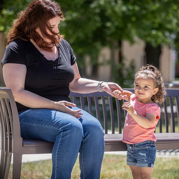 Mom and foster daughter outside in a park