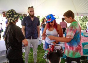 Two teenagers telling their mom what they won while Case Manager looks on